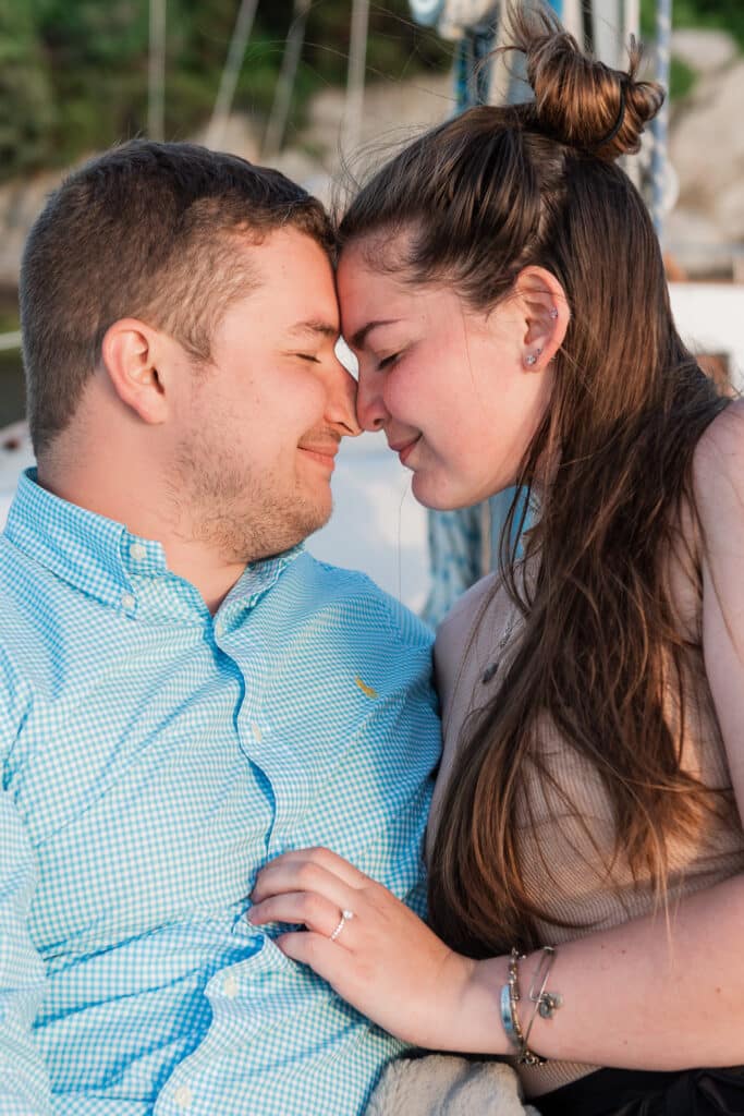 couple shares intimate moment afternewport proposal on a sunset cruise