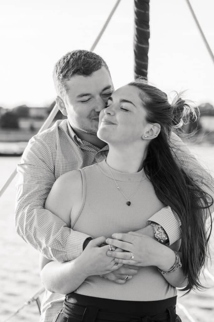 couple smiles on sunset cruise in Newport rhode island