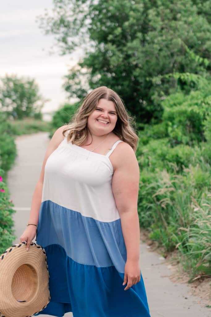 girl swishes dress for beach senior portraits in portsmouth