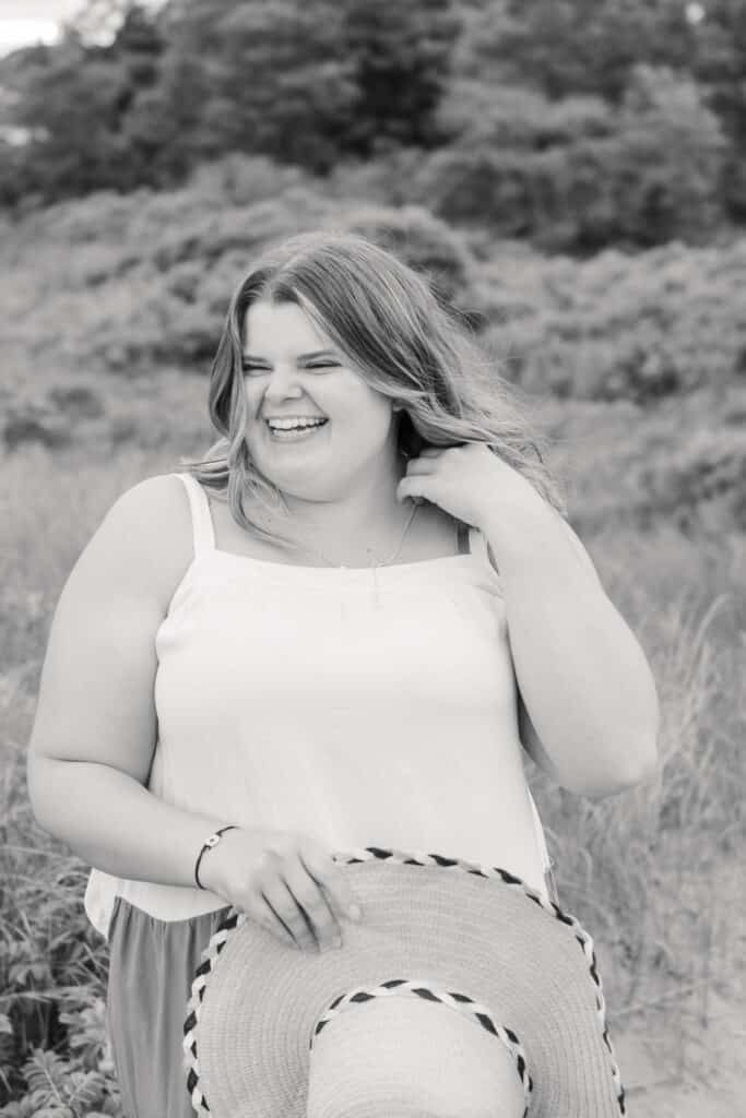 senior girl laughs for portraits