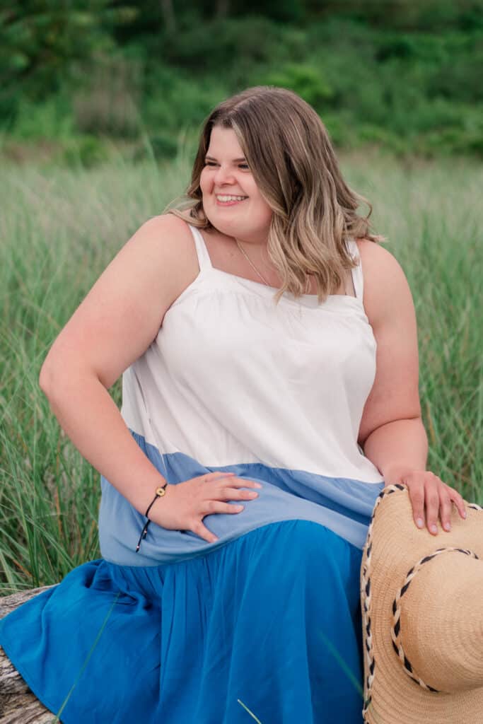 girl looks over shoulder for beach portraits at sandy point