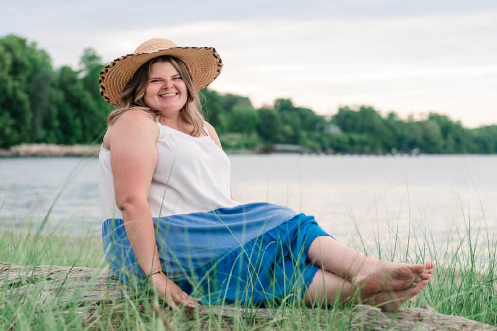 senior girl poses at beach