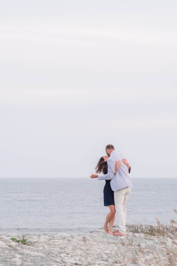 couple hugs after second beach proposal