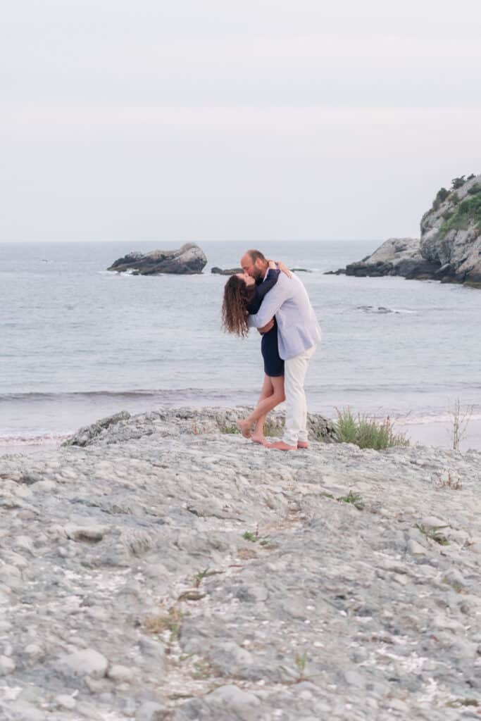 couple hugs on rocks at surfer's end