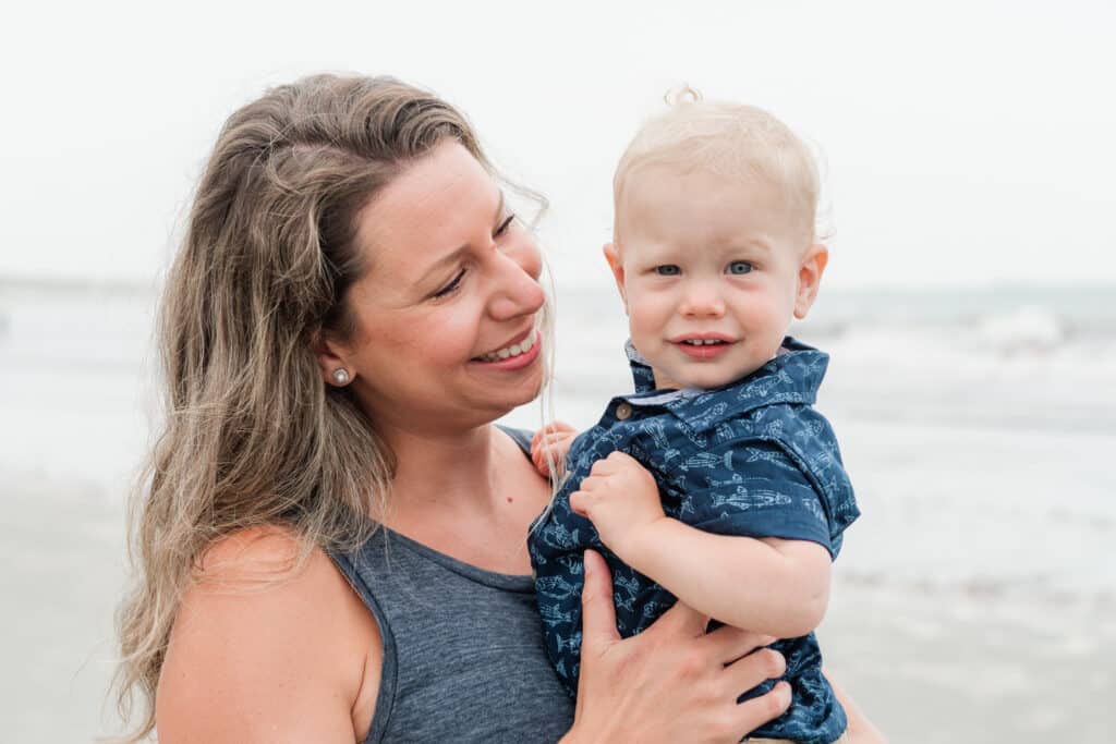 woman snuggle son during family portraits in middletown