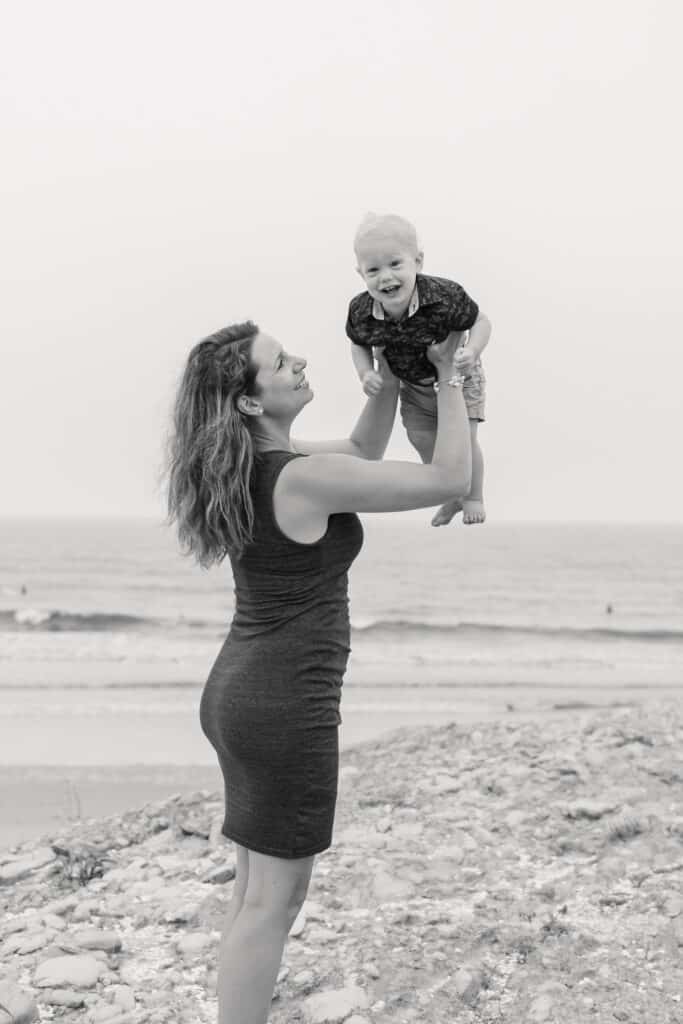 boy laughs for family portraits on beach