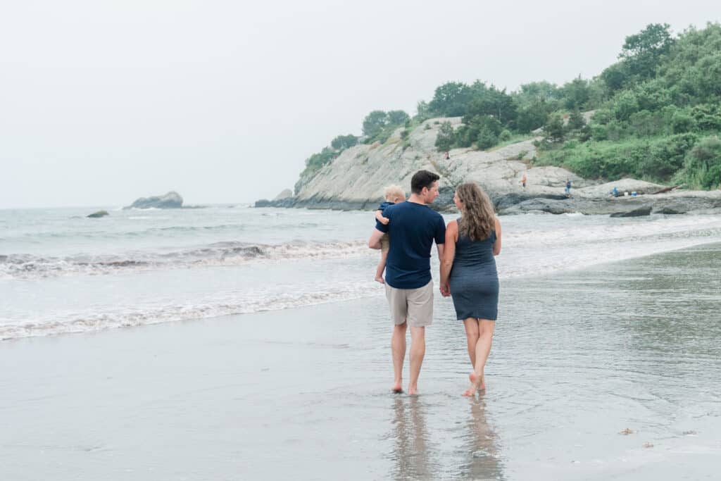 family walks on sachuest beach for family portraits