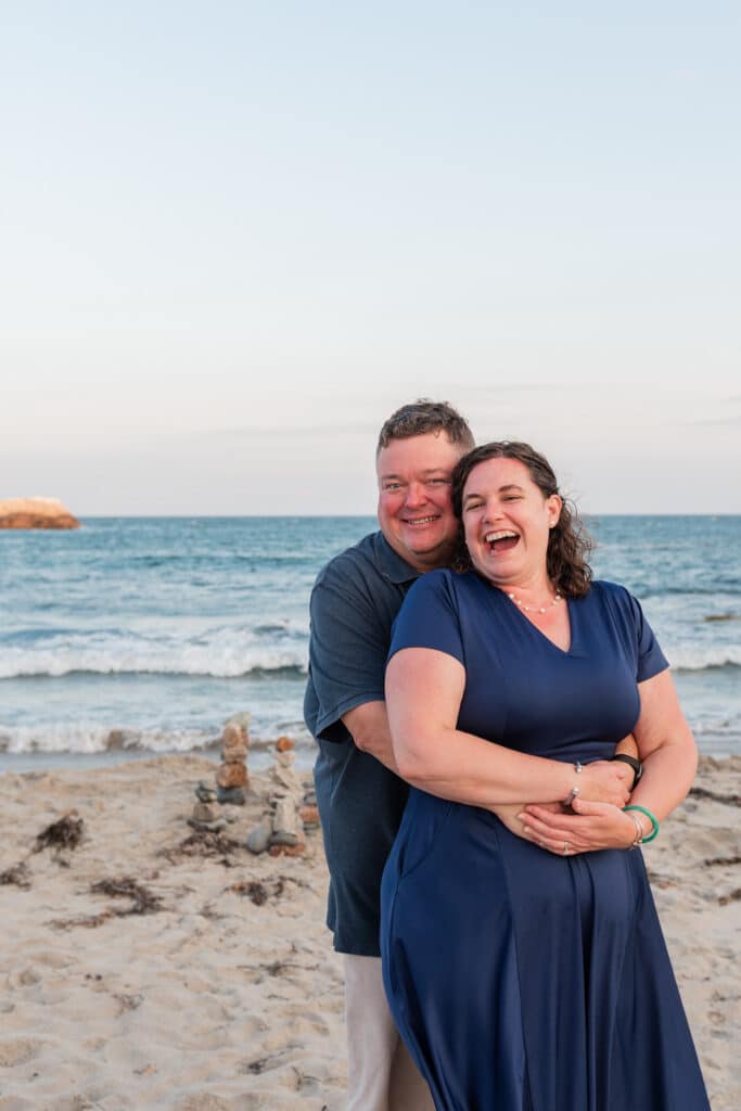 couple laughs on beach