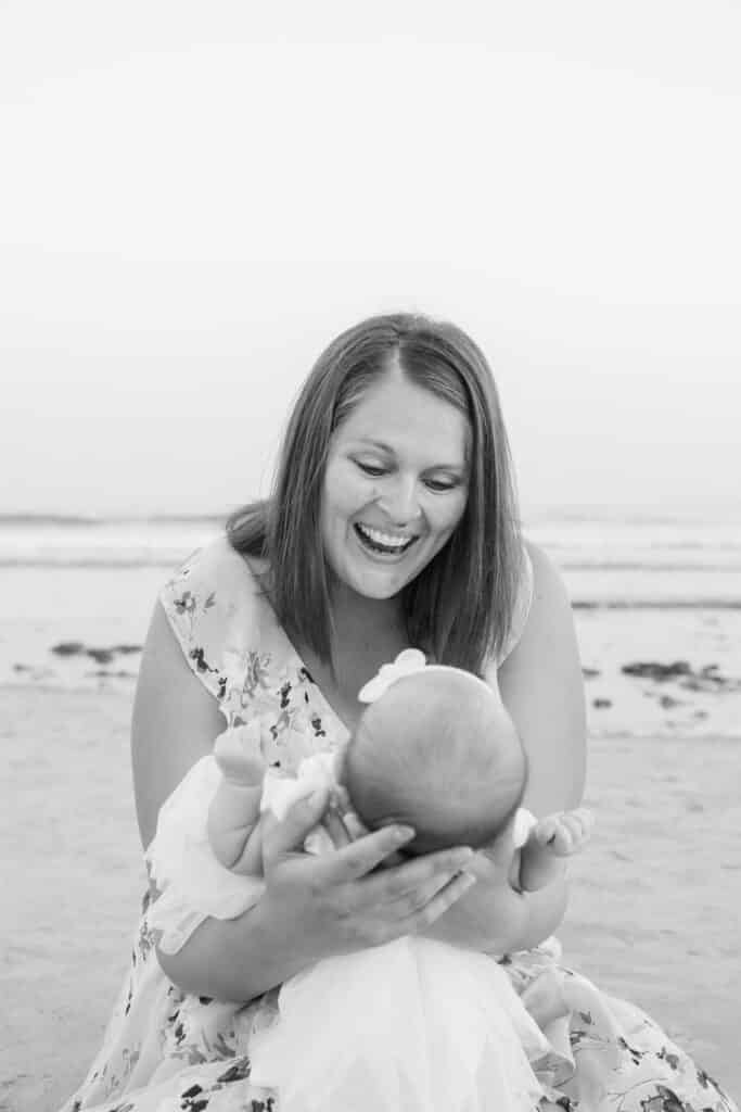 mom laughs during newport ri newborn portrait session