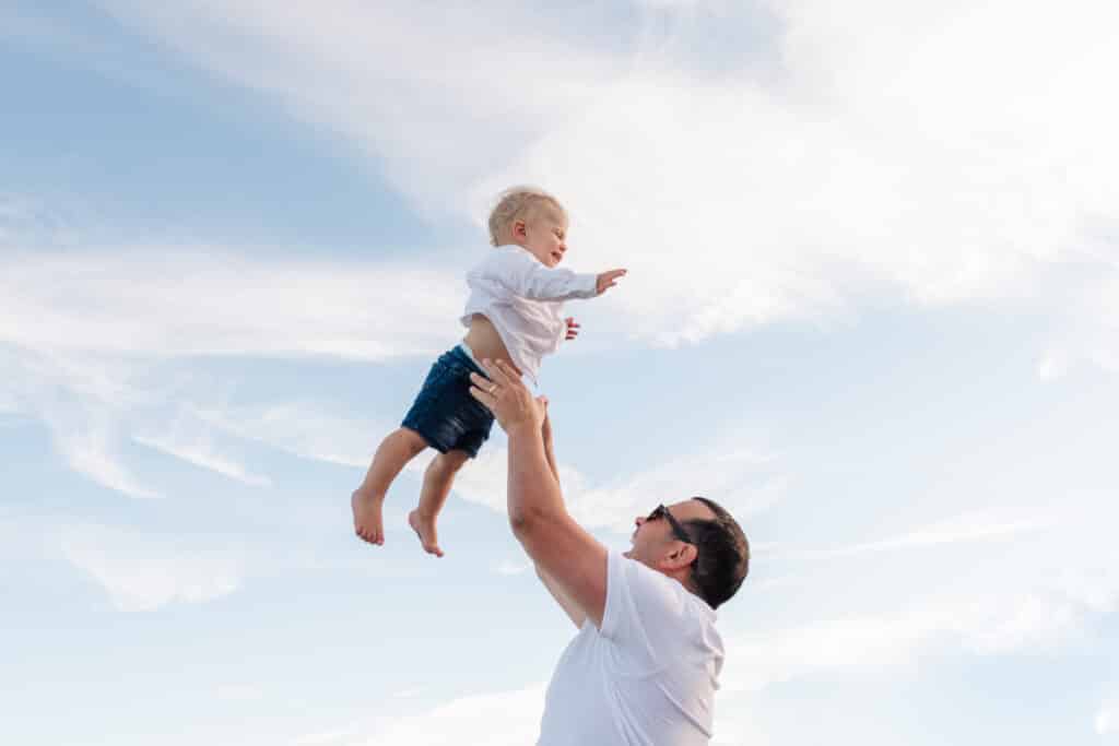 dad tosses toddler in the air