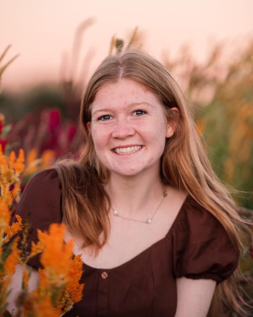 girl smiles for senior portraits at sweet berry farm