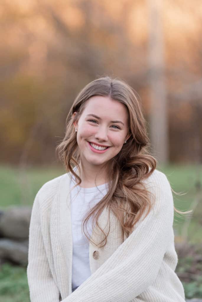 senior smiling on a rock