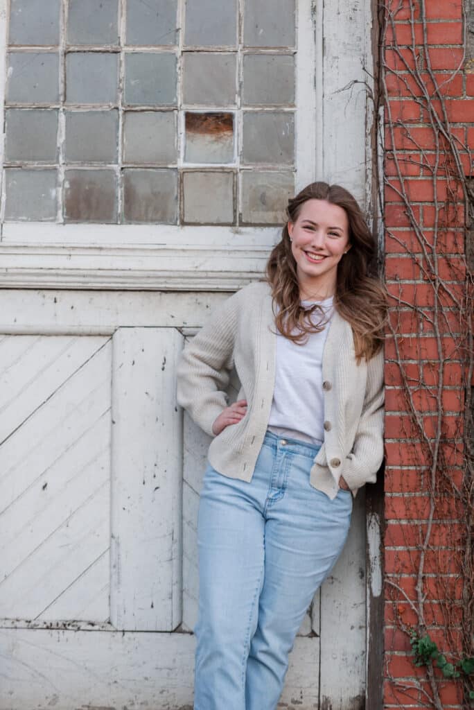 senior standing near wall