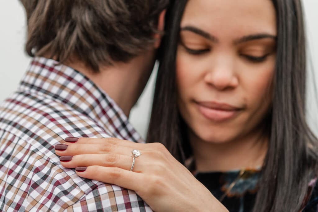 close up of woman with diamond engagement ring