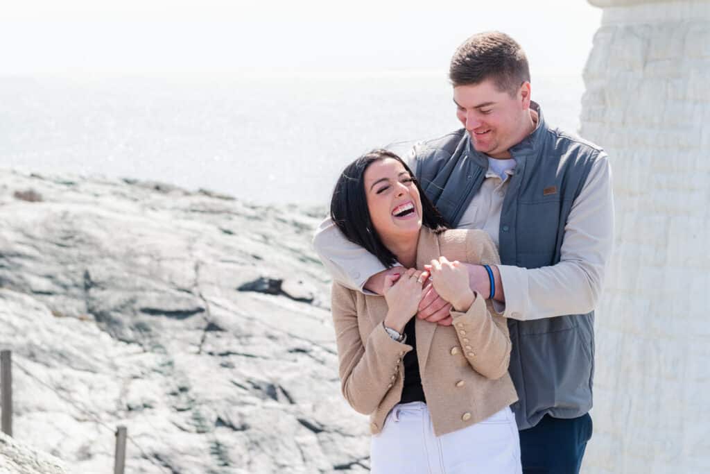 couple laughs at lighthouse