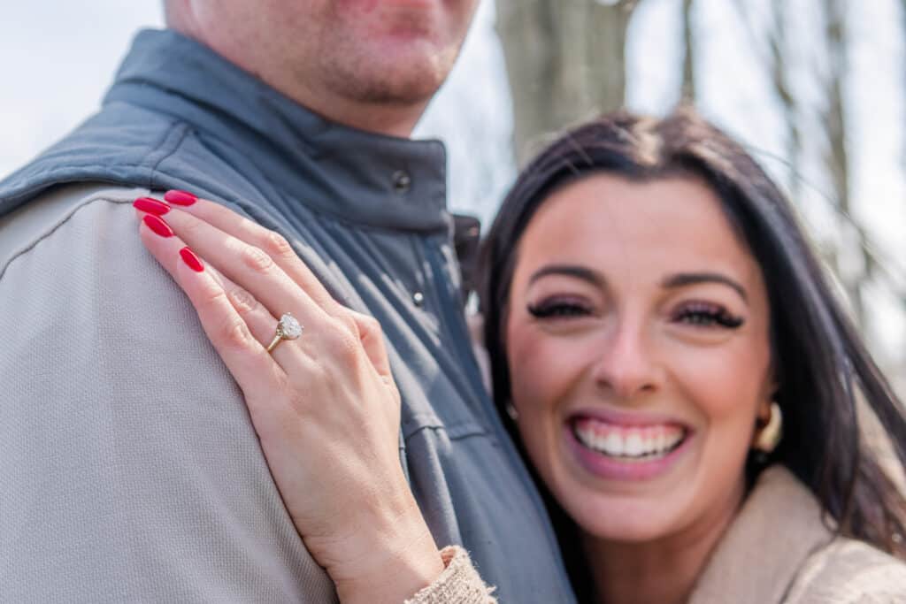 woman with engagement ring smiles