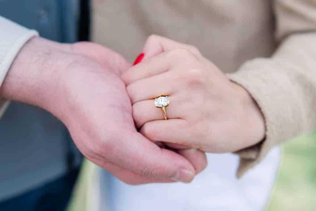 engaged couple holds hands