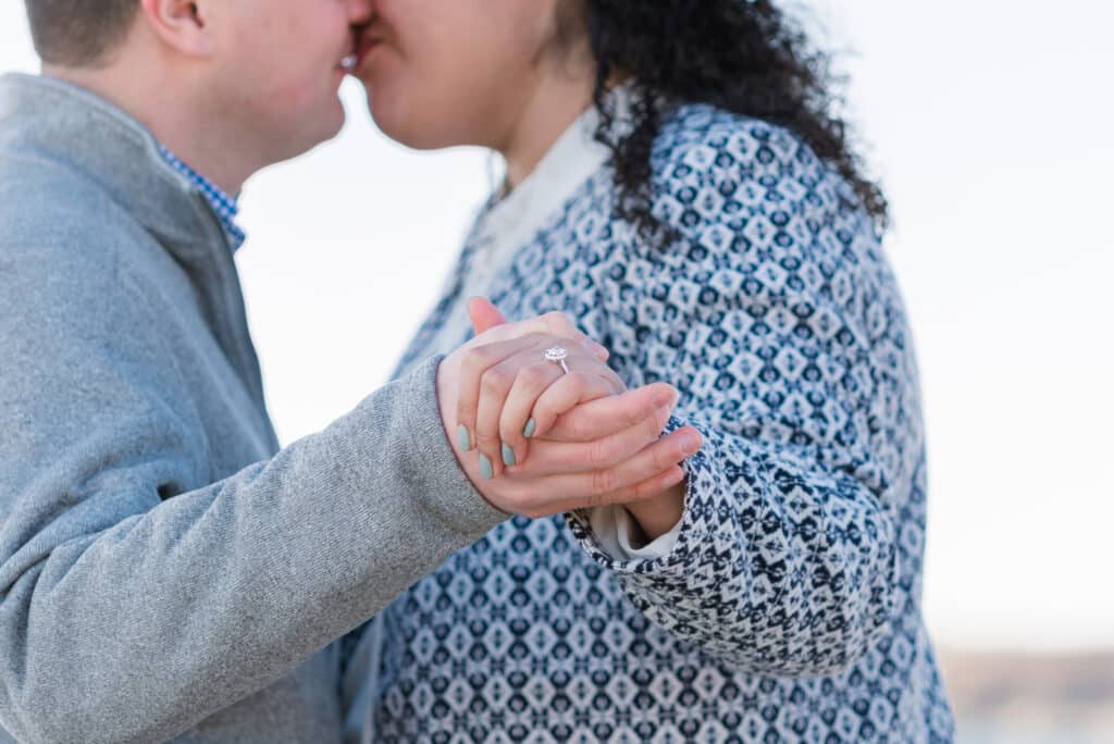 couple kisses for spring proposal at castle hill