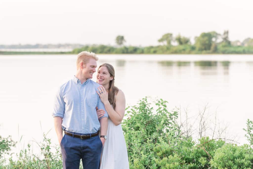 couple smiles near water at colt state park in bristol