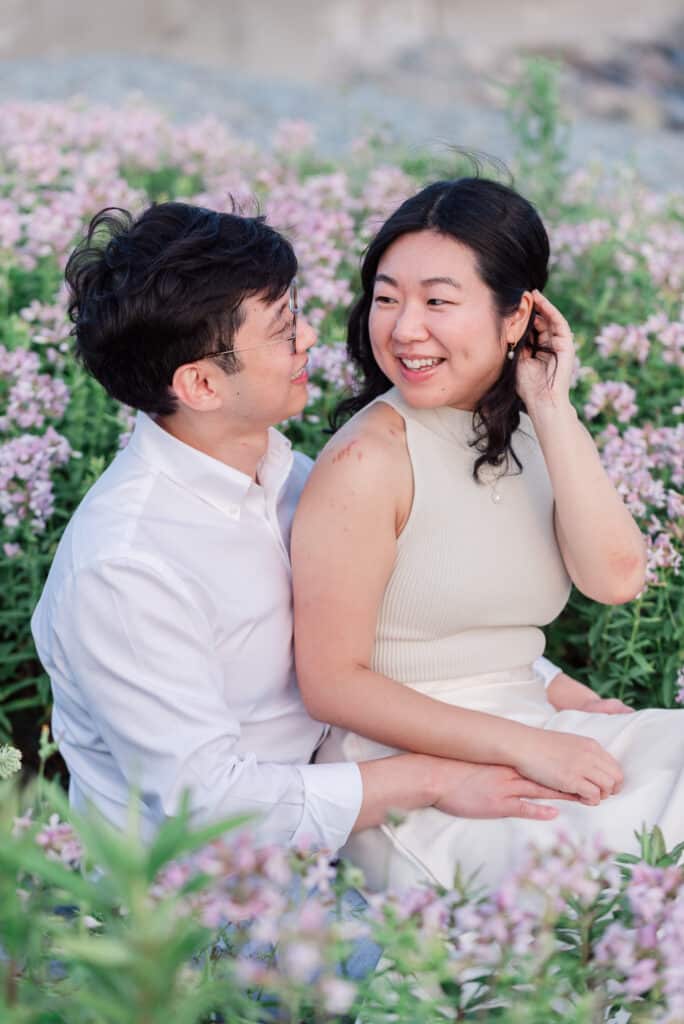 couple sits among flowers in newport