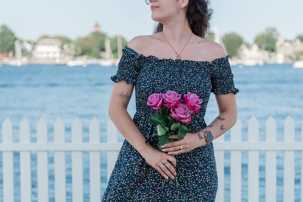 woman stands near goat island lighthouse after engagement